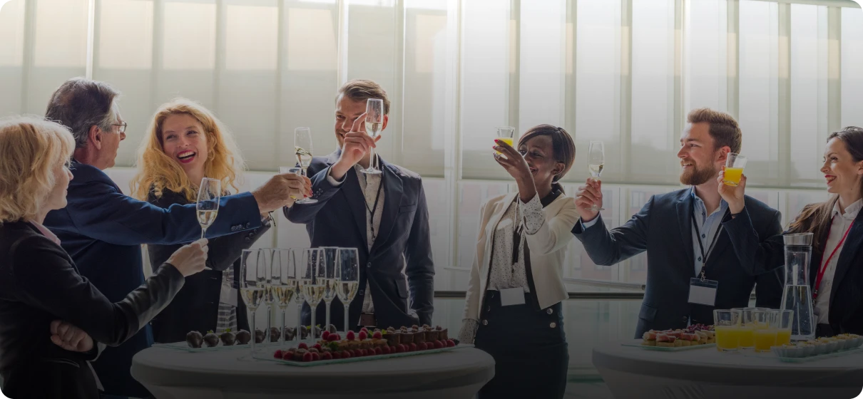 Group of people raising glasses at party